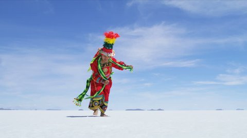View of Bolivian Latin American female proudly performing traditional dance in National dress on South American Salt flats RED WEAPON