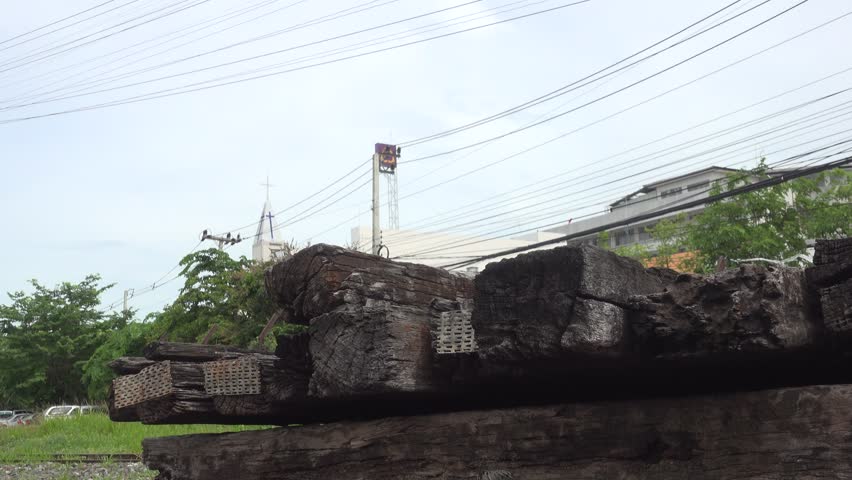Moving dolly over abandoned wood train vials supported metal rail