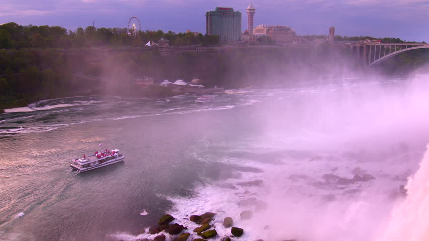 Tourist boat and Rainbow Bridge at Niagara Falls. 4K