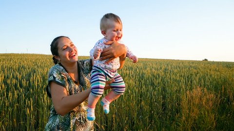 Mom throws up and catches her little daughter In the wheat field Slowmotion Full HD
