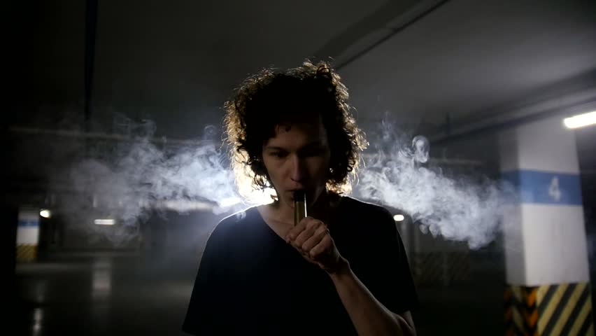 Vaper releases a cloud of steam into the camera lens