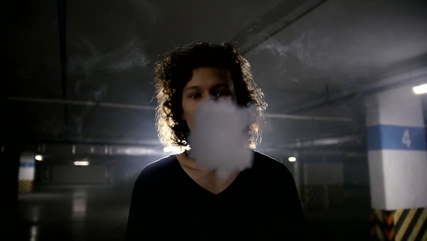 Vaper releases a cloud of steam into the camera lens