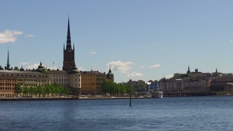 Stockholm Old Town (Gamla Stan) with ancient steam ferry and conventional boats used by tourists