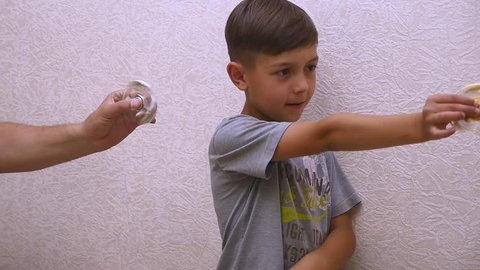 Boy with spinner. Hand spinner, or fidgeting spinner, rotating on hand. Slow motion.