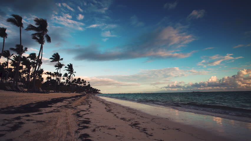 Ladscape of paradise tropical island beach Punta Cana, Dominican Republic. Man running at sunrise.