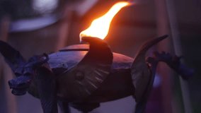 a Homemade Metal Kerosene Lamp. the Lamp is Stylized With Help of Metal Sheets. a Beautiful Yellow Flame Burns in the Lamp. the Lamp is Located in a Center of a Reconstruction Camp. Video in a Super