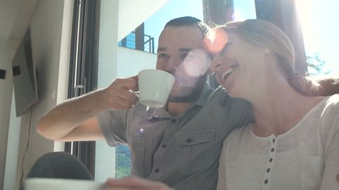 couple relaxing at home with a cup of coffee