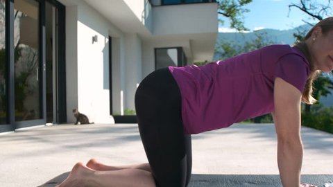 Fitness Woman Doing Stretching in front of mansion