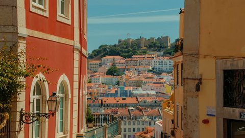 Tilting establishing shot of the downtown of Lisbon, Portugal showing the Castelo de Sao Jorge castle