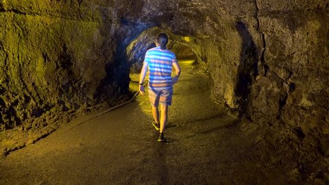 Tourist in the Thurston Lava Tube (Nahuku). Volcanoes NP, Big Island, Hawaii, USA