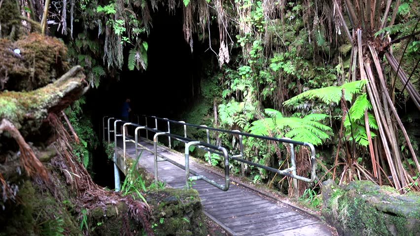 Girl at the gate of Thurston Lava Tube (Nahuku). Volcanoes NP, Big Island, Hawaii, USA