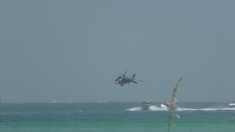 Helicopter and patrol boats in a chase