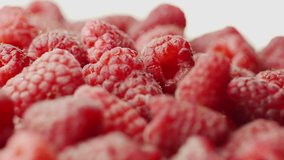 Juicy red raspberries, spin on white background.