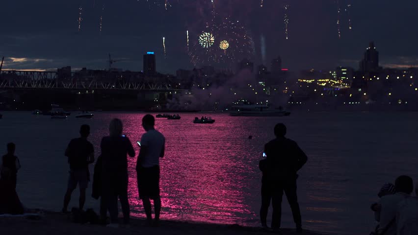 people silhouettes on a background of fireworks. group of people enjoying the city night view and fireworks Royalty-Free Stock Footage #28150036