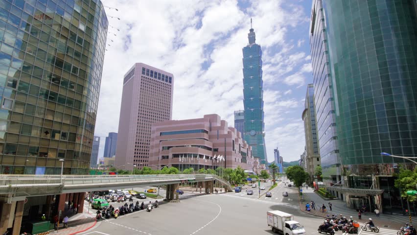 Taipei 101 Tower and beautiful Cityscape with a cars, motorbikes and traffic on the road with landmark supertall skyscraper in Xinyi District-Dan