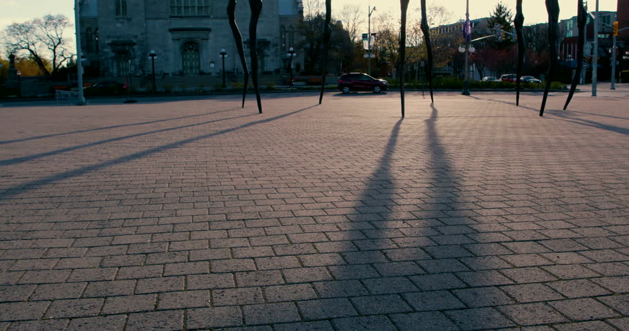 Tilt Up of Downtown Ottawa Giant Spider Statue and Waving Canadian Flags with Notre-Dame Cathedral Basilica in