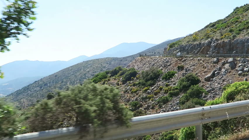 View to bay of Malia (Crete Greece). driving along with a road train in the mountains.