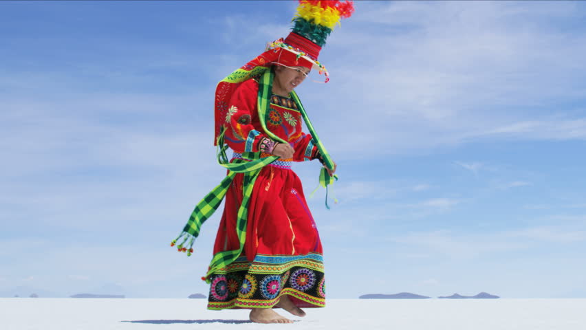 Traditional Bolivian dance performed proudly by Indigenous South American female on Salar de Uyuni Salt flats wearing traditional costume 