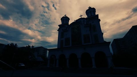 Time lapse of stormy clouds flying over orthodox church. Dramatic cloudy sky. Low angle, wide lens. Natural light.
