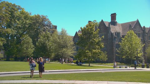 DURHAM, NC - 2017: Duke University on Graduation Day with Students and People Walking on Campus with the Trinity College of Arts and Sciences in the Background