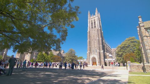 DURHAM, NC - 2017: University Chapel during Graduation with People In Front of the Iconic Landmark Building Exterior on a Sunny Day in North Carolina