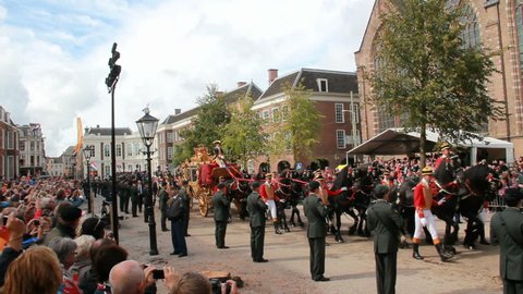 THE HAGUE, HOLLAND - SEPTEMBER 19: Golden Coach with Queen Beatrix of Holland rides on Prinsjesdag on September 19, 2012 in The Hague, Holland. Prinsjesdag is opening of Parliamentary year in Holland