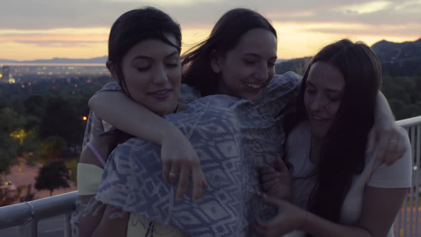 Happy Girls Have Group Hug And Laugh Really Hard At A Viewpoint, City And Mountains In Background  Royalty-Free Stock Footage #28183357