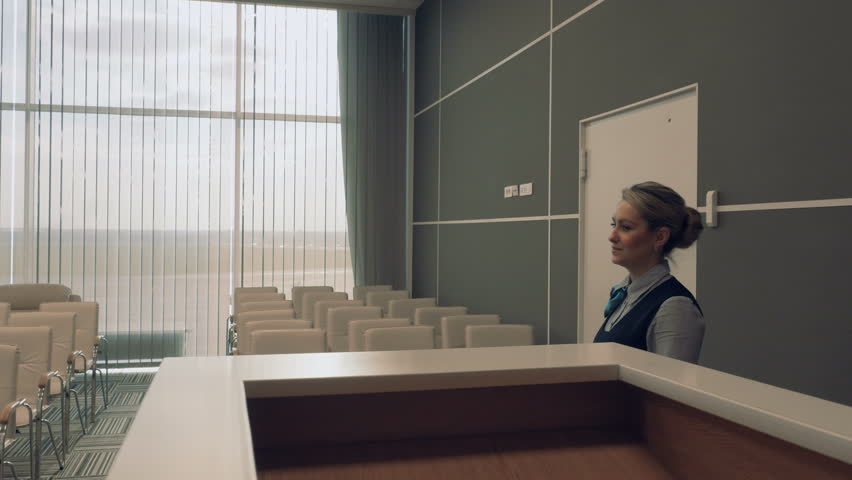 Young airport employee in the conference hall checks the room | Shutterstock HD Video #28188580
