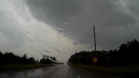 Arthur, Ontario, Canada June 2017 Driving into severe thunderstorm, dark clouds and heavy rain POV 