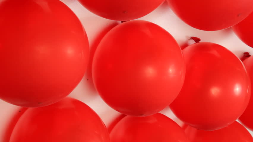 Red balloons popping at carnival