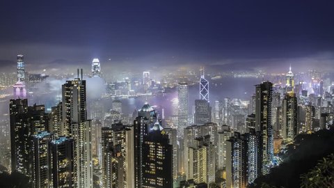 Time lapse Hong Kong skyline from famous The Peak view point at night. Wow-Effect: Clouds rushing through skyscrapers.