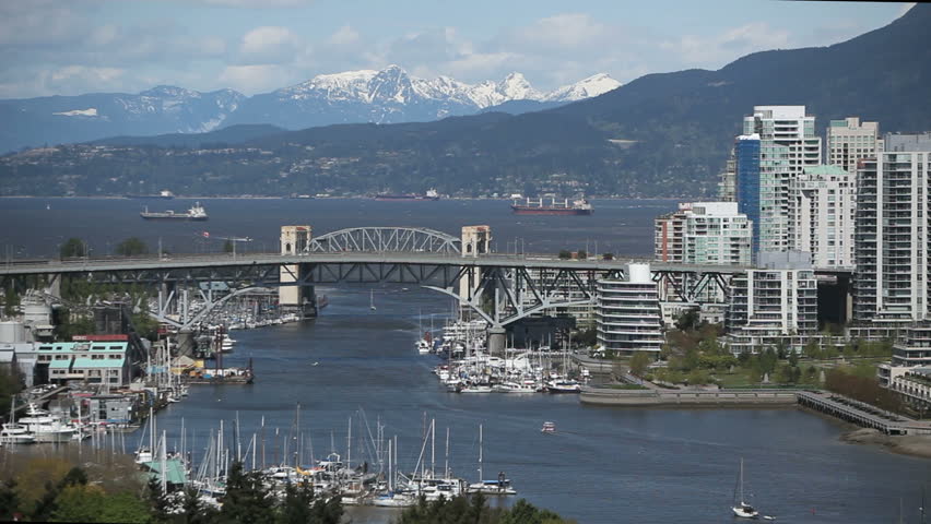 Vancouver Skyline during daytime with boats on the river