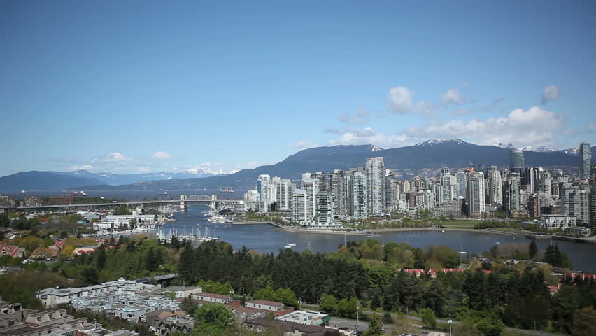Vancouver Skyline during daytime with boats on the river