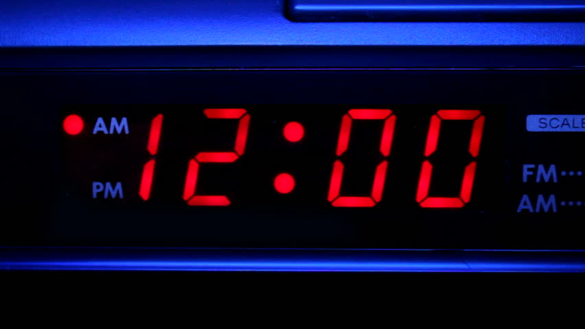Closeup video of clock radio with blinking red 12:00