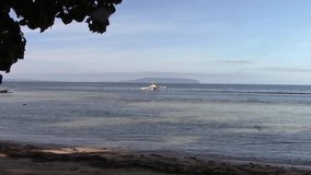 a fishing boat in the sea of Sulangan at Banago beach, Calicoan island, Eastern Samar, Philippines. edited video.
