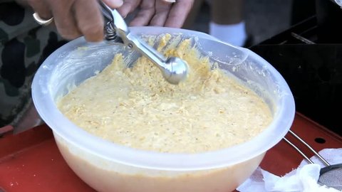 Hushpuppy Batter Being Scooped With Small Scoop From Plastic Bowl