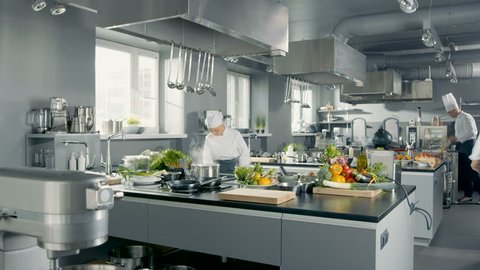 Time-Lapse Panoramic Shot of Big Restaurant Kitchen and Three Chefs Working. Shot on RED EPIC-W 8K Helium Cinema Camera.