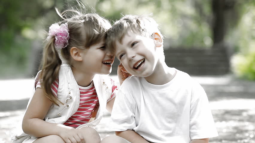 Two children laughing in park, outdoors