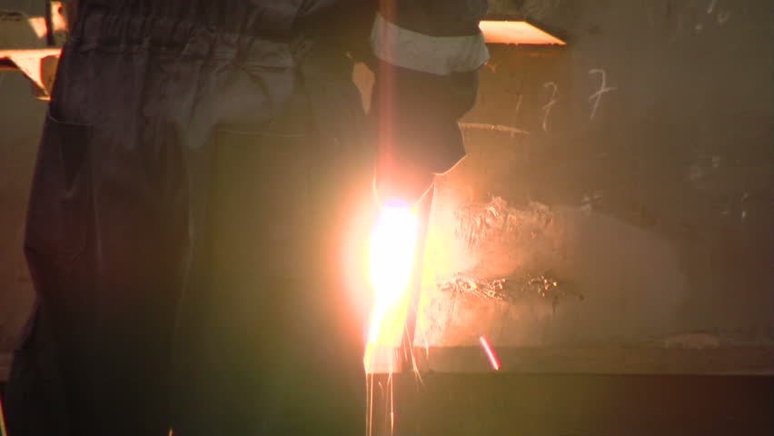 Man welding in shipyard