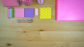 Back to School or Education Concept with stationery and desk accessories overhead, time lapse.