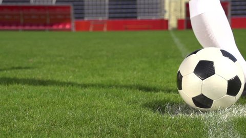 detail soccer player kicking ball on field slow motion
