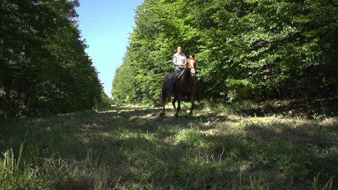 woman on galloping horse in slow motion