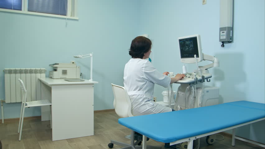 Woman doctor working at ultrasound diagnostic machine | Shutterstock HD Video #28238254