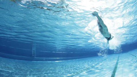 underwater view professional swim training in swimming pool, freestyle crawl