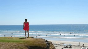 High quality video of woman standing at the cliff in San Diego