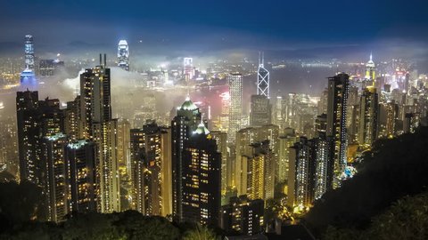 Time lapse Hong Kong skyline from famous The Peak view point at night. Wow-Effect: Clouds rushing through skyscrapers.
