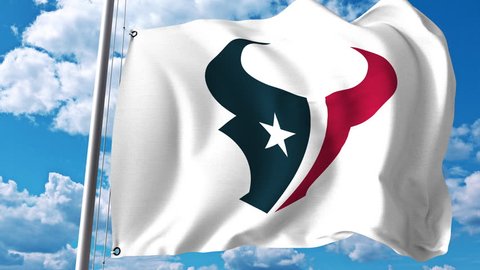 Waving flag with Houston Texans professional team logo. 4K editorial clip