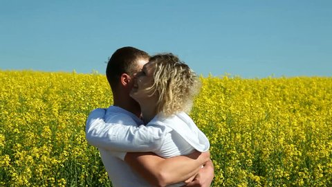 sweet couple in a field of rape