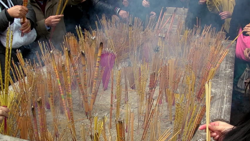 GUANGZHOU - JANUARY 23: People burn incense in temple during Chinese New Year,