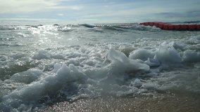 SLOW MOTION of ocean waves at the beach closeup with sunset background